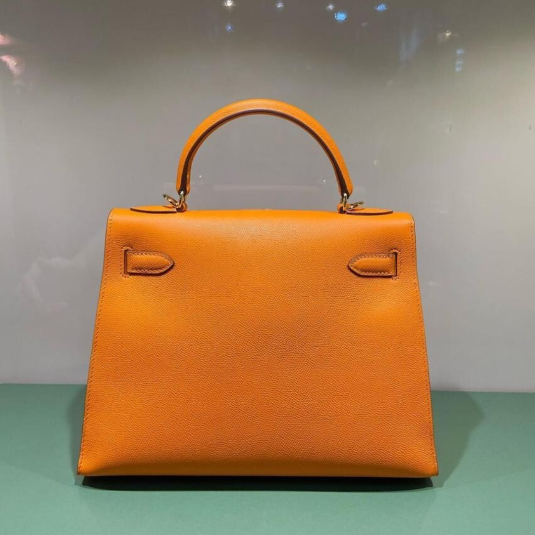 HERMÈS KELLY 25 BAG WITH GOLD HARDWARE IN ORANGE